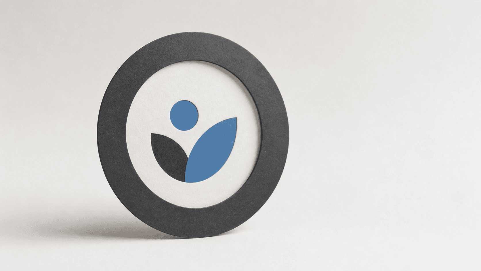 Circular avatar frame with a centered abstract mark on a clean studio background